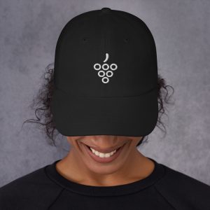 Minimal grape symbol embroidered in white on a black dad cap